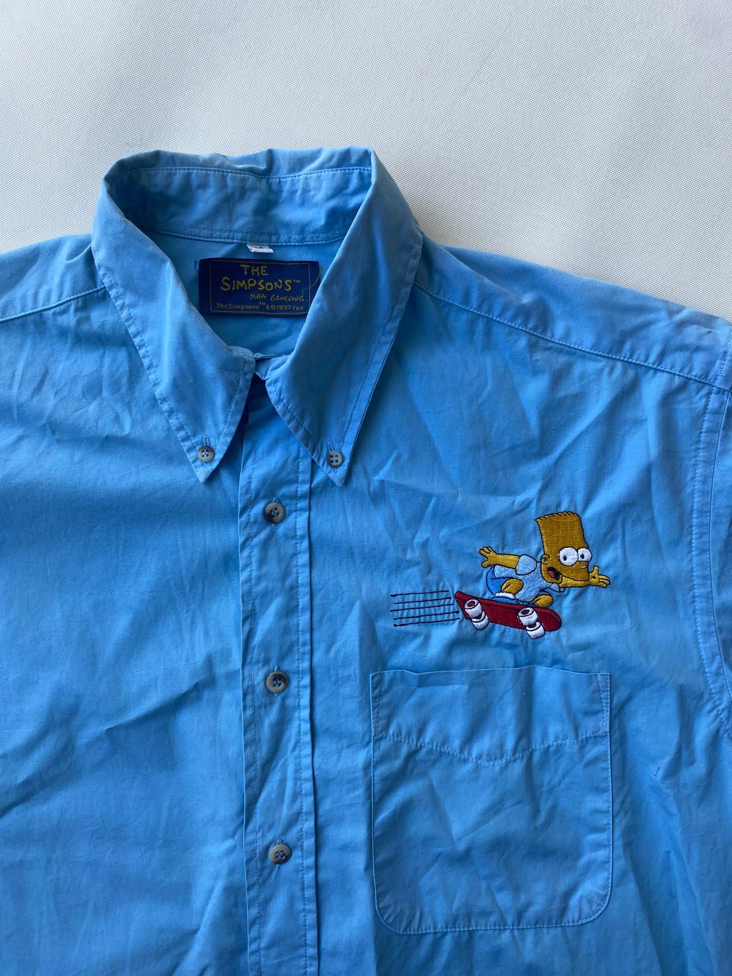 ✅ Chemisette collector Les Simpsons, bleu ciel, L