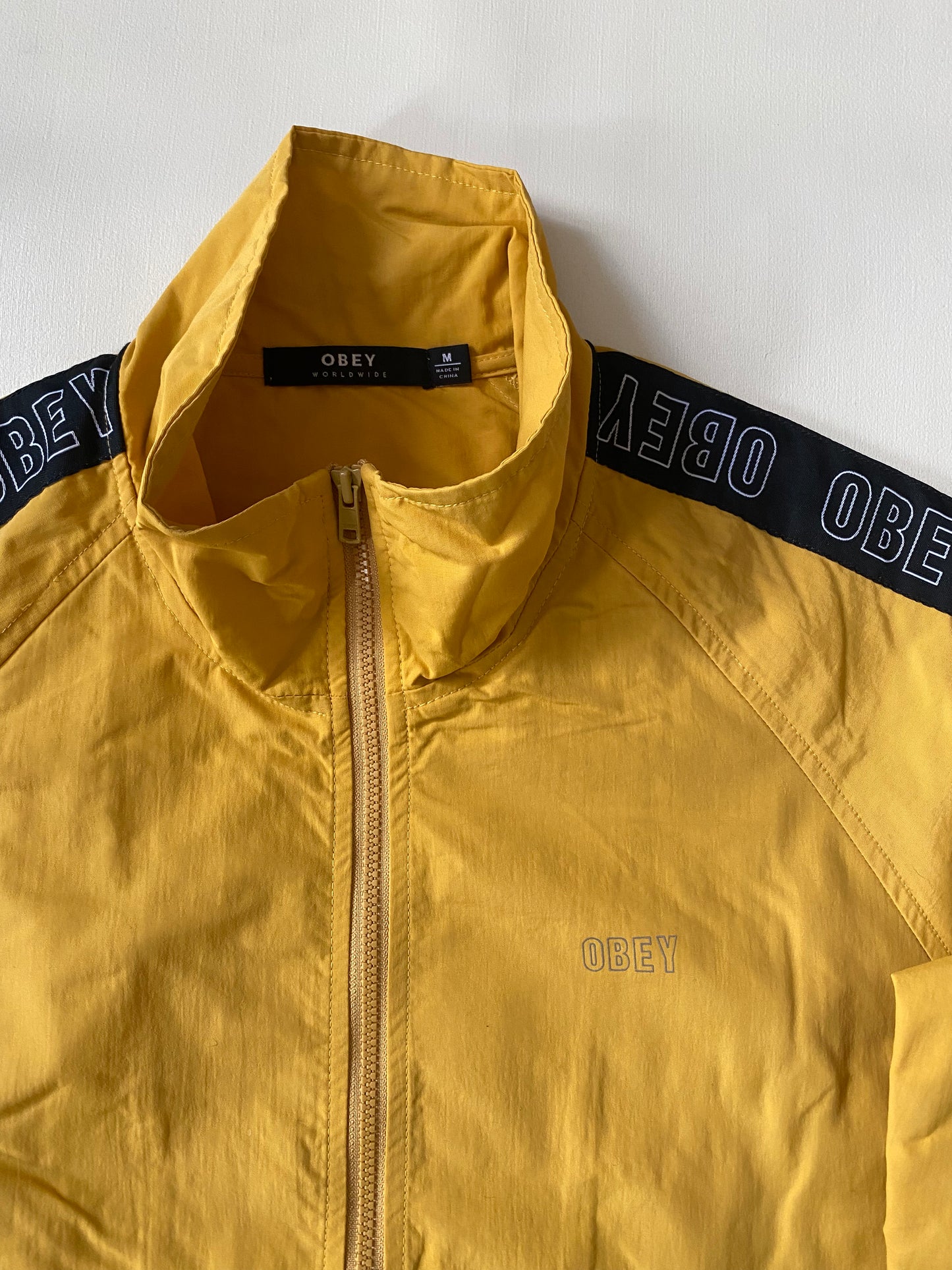 Coupe-vent / pluie Obey, jaune et noir, M